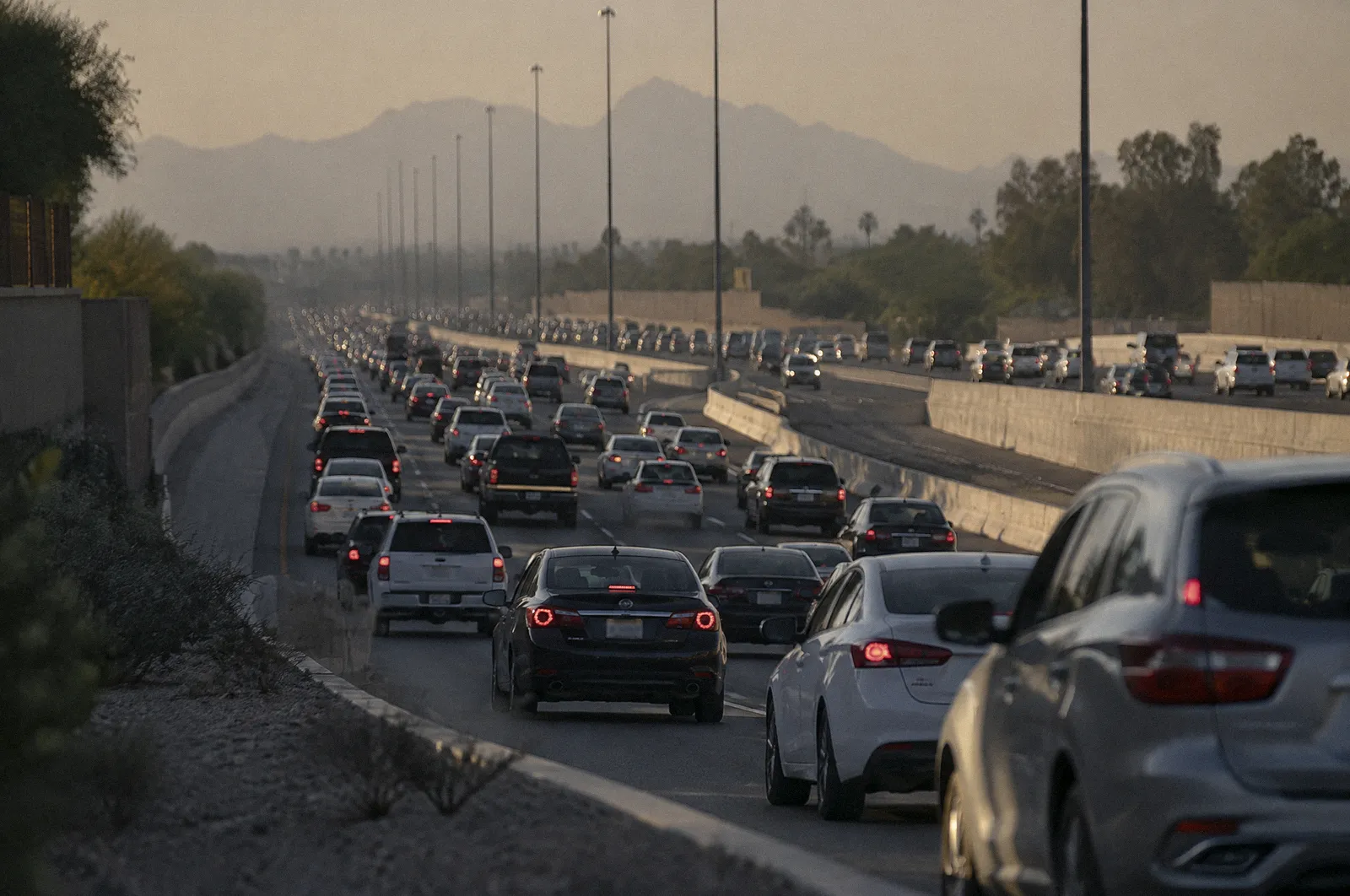 Stop-and-go freeway traffic on a Phoenix interstate at rush hour, long lens compression, heat haze