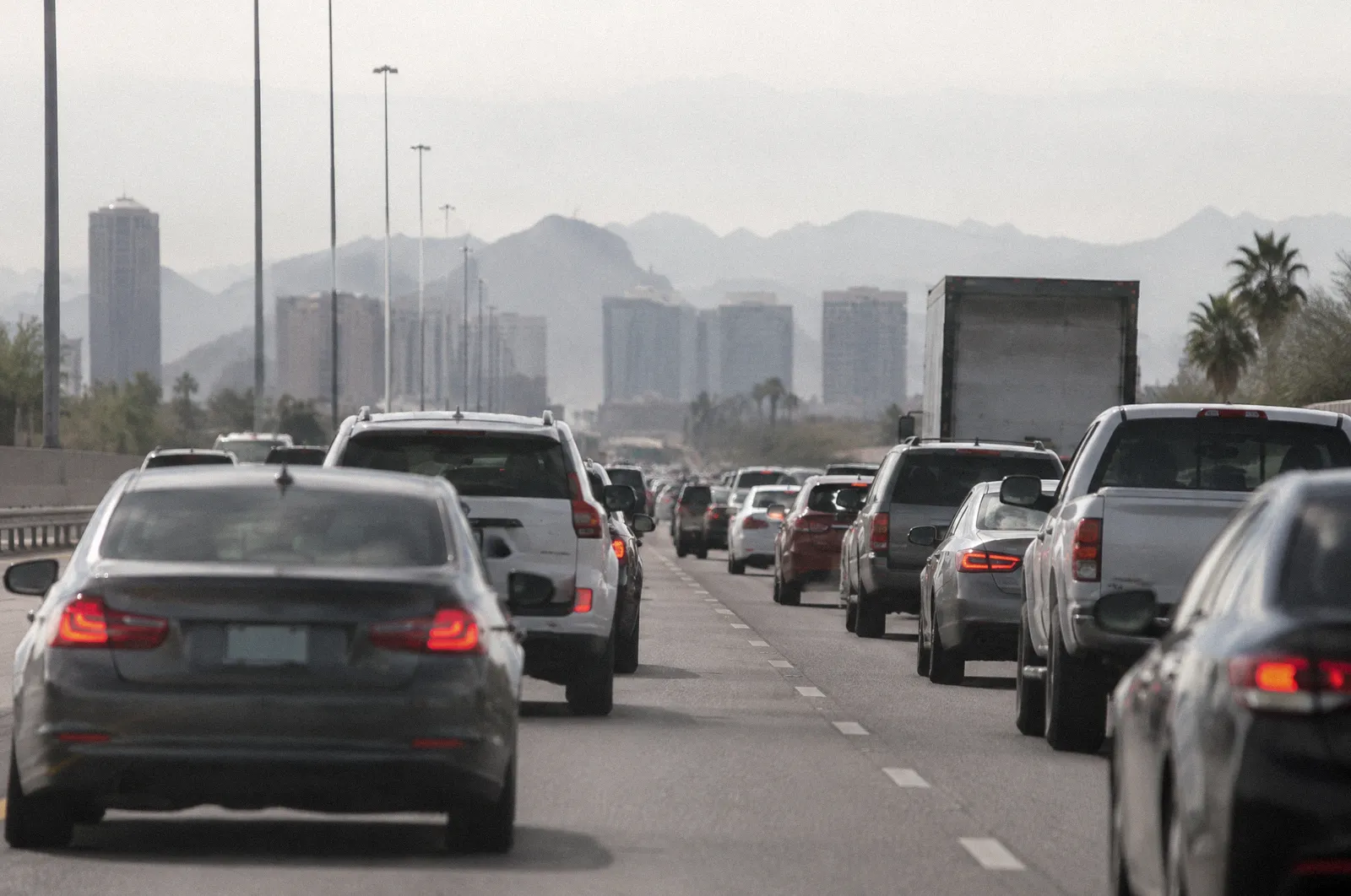 Stop-and-go freeway traffic on a Phoenix interstate at rush hour, long lens compression, heat haze