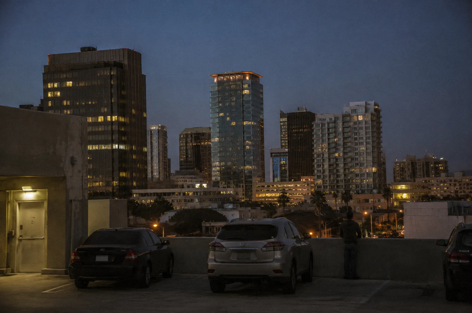 Downtown Phoenix skyline at blue hour from a parking structure, mid-rise towers, no readable building names