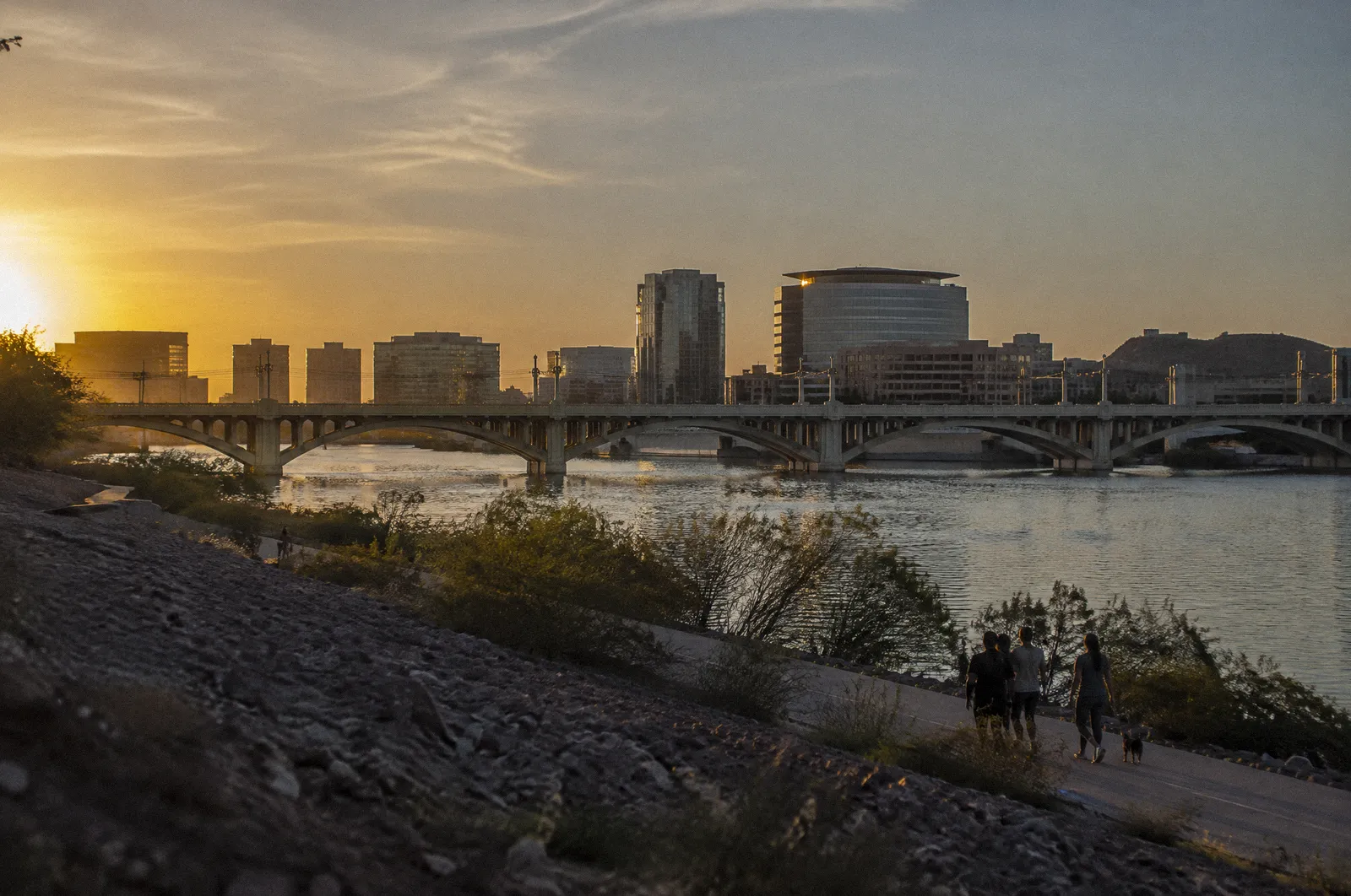 The Tempe Town Lake area with a long bridge and the Mill Avenue area skyline, golden hour