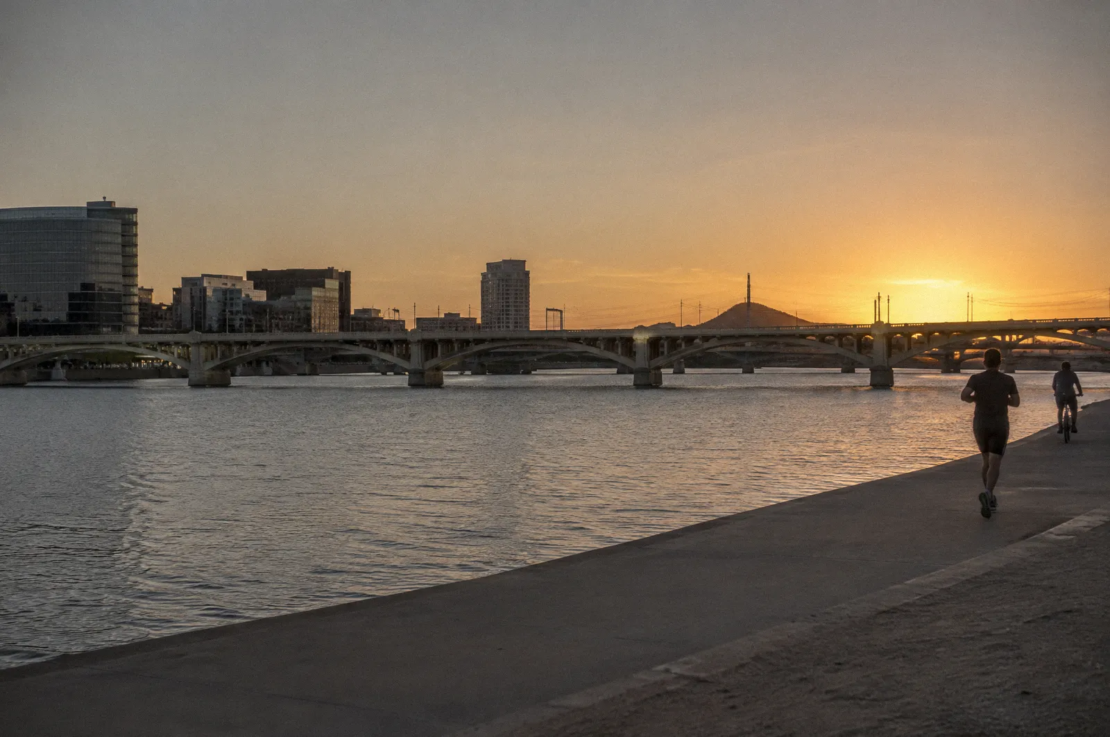 The Tempe Town Lake area with a long bridge and the Mill Avenue area skyline, golden hour