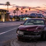 Abandoned damaged vehicle at a Phoenix area intersection at dusk representing hit and run accidents in the Phoenix area Abandoned damaged vehicle at a Phoenix area intersection at dusk representing hit and run accidents in the Phoenix area