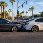 Two vehicles on a Scottsdale Arizona roadway after a rear-end collision, showing bumper and front-end damage at a sunlit intersection Two vehicles on a Scottsdale Arizona roadway after a rear-end collision, showing bumper and front-end damage at a sunlit intersection