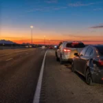 Uninsured and underinsured motorist coverage in Arizona: two cars on a Phoenix freeway shoulder after a collision at dawn Uninsured and underinsured motorist coverage in Arizona: two cars on a Phoenix freeway shoulder after a collision at dawn