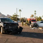 Damaged vehicles at an Arizona intersection representing traumatic brain injury car accident cases handled by Valley Accident Law Damaged vehicles at an Arizona intersection representing traumatic brain injury car accident cases handled by Valley Accident Law