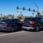 Rear-end car accident aftermath at a Phoenix Arizona intersection representing whiplash and soft tissue injury claims