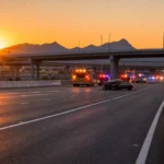 Phoenix metro highway at dawn with emergency vehicles at a fatal car accident scene, representing wrongful death from a car accident in Arizona