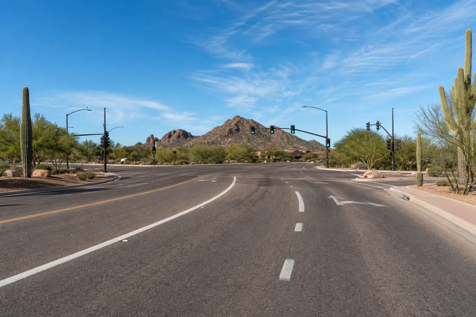 Valley Accident Law | Why Motorcycle Injury Claims Get Lowballed in Arizona and How Road Rash and Lane Position Are Used Against You Scottsdale Arizona intersection showing lane markings on asphalt, representing how lane position factors into motorcycle injury claims